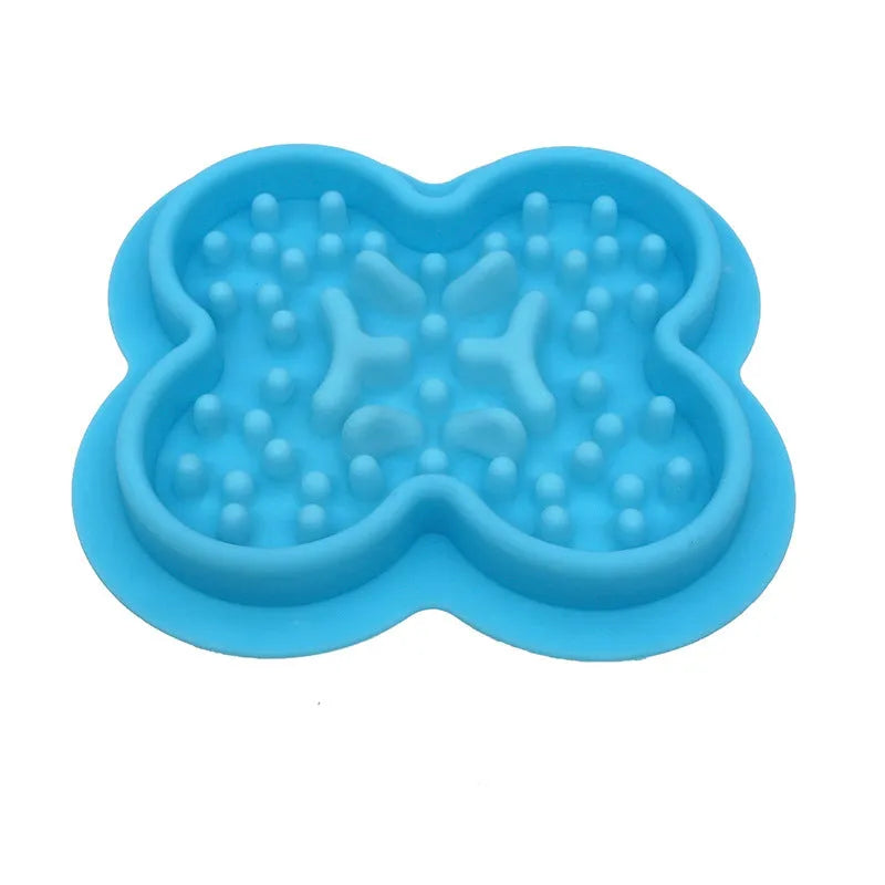 Silicone pet slow feeder licking mat with raised edges in assorted colours on a kitchen floor.