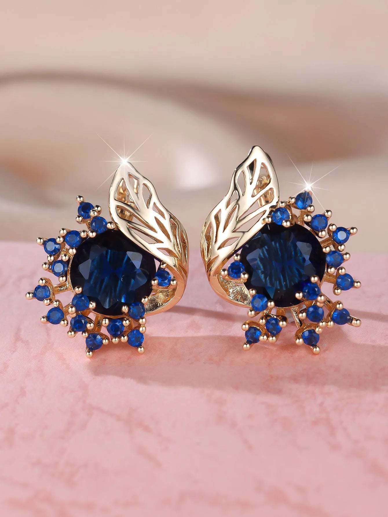 Round floral feather earrings in rose gold colour with crystal zircon stones, shown in six colour variations