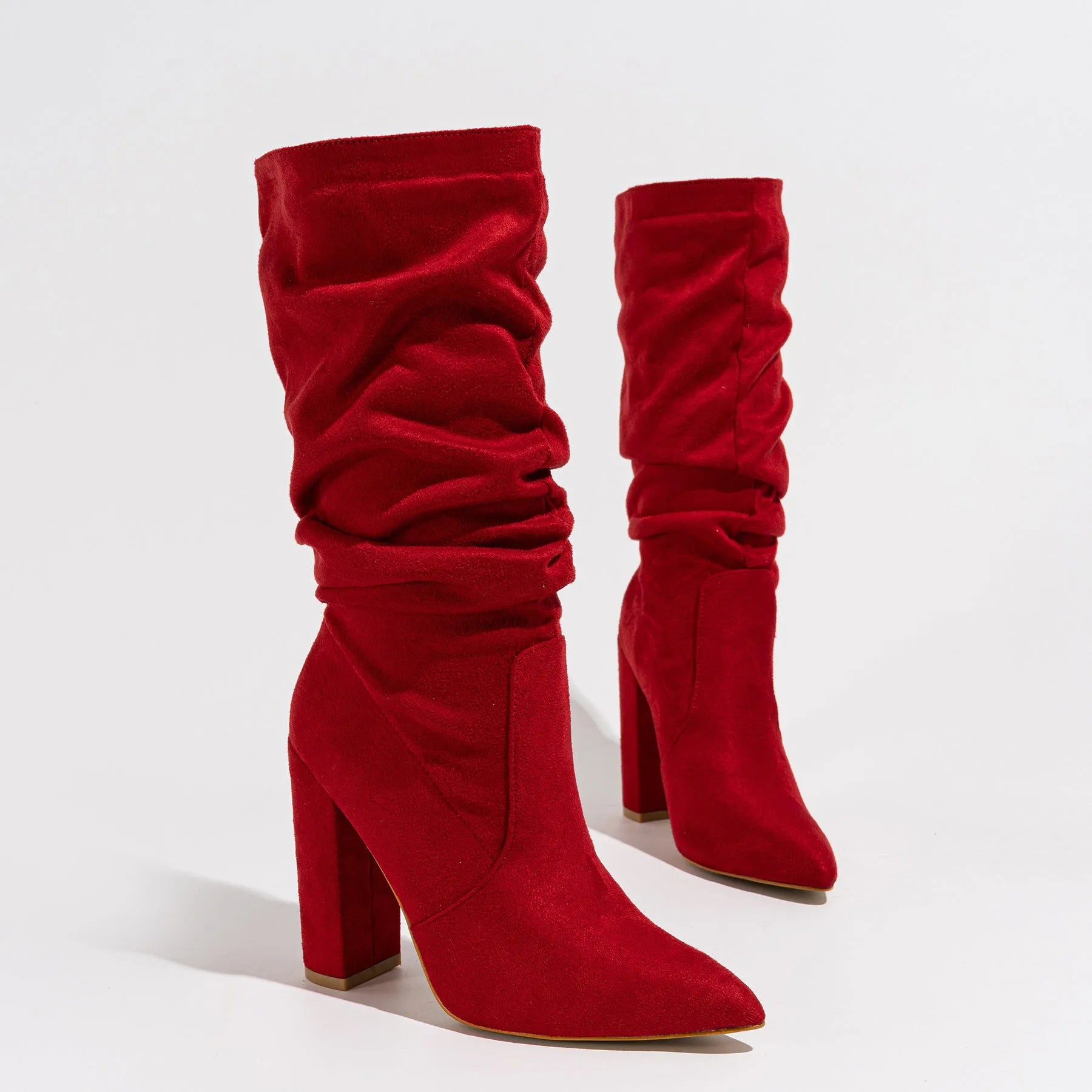 Women's black suede chunky heel pointed-toe boots with a high heel above 8cm and calf-length socks.