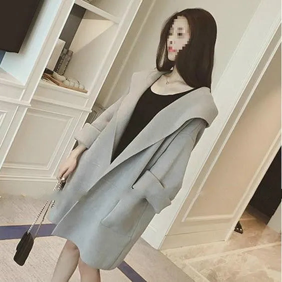 Plus size woman modelling a loose grey cotton coat with lace details for spring or autumn.