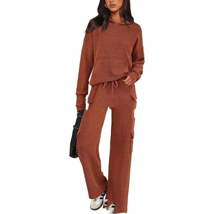 Women's two-piece leisure sports suit in polyester, showing long sleeve top and trousers in a solid colour.