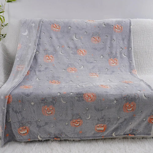 Children's cartoon flannel blanket in colourful design on bed