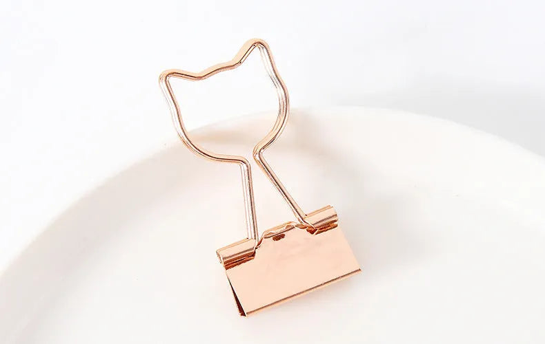 Gold-plated decorative binder clips showing flamingo, love, clouds, cat, cactus and bow designs