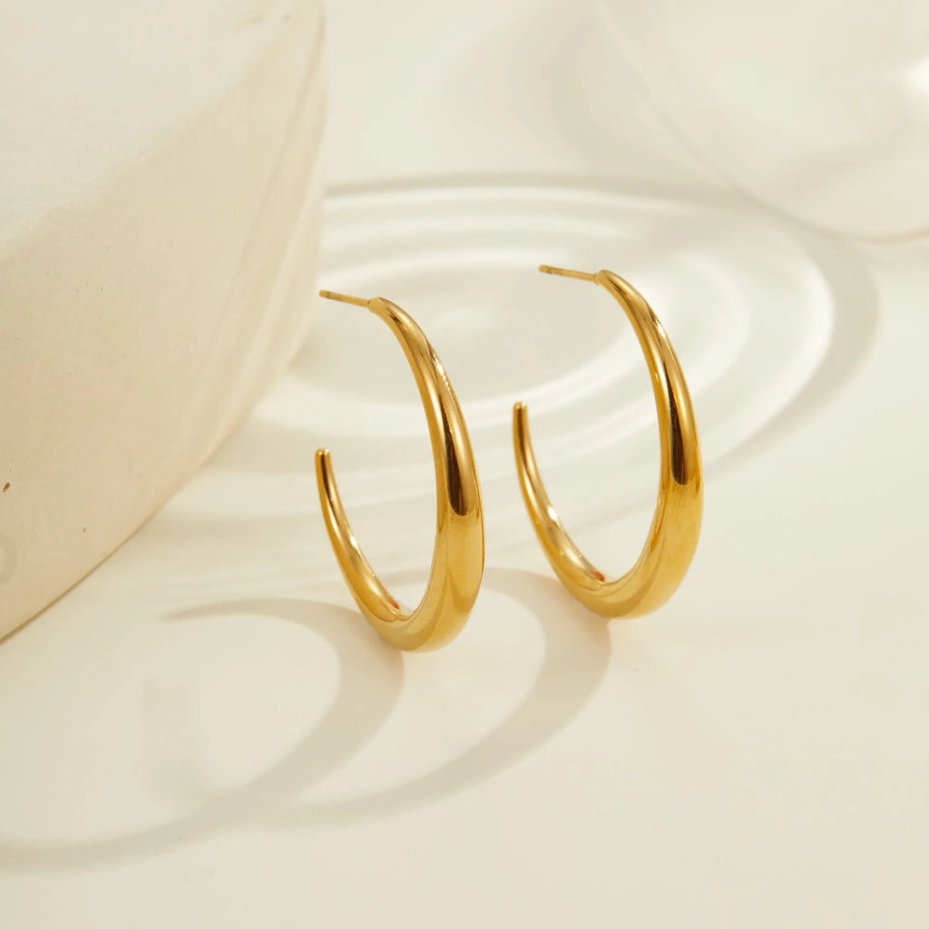 Simple round stainless steel hoop earrings for women in gold and steel colours, available in two sizes.