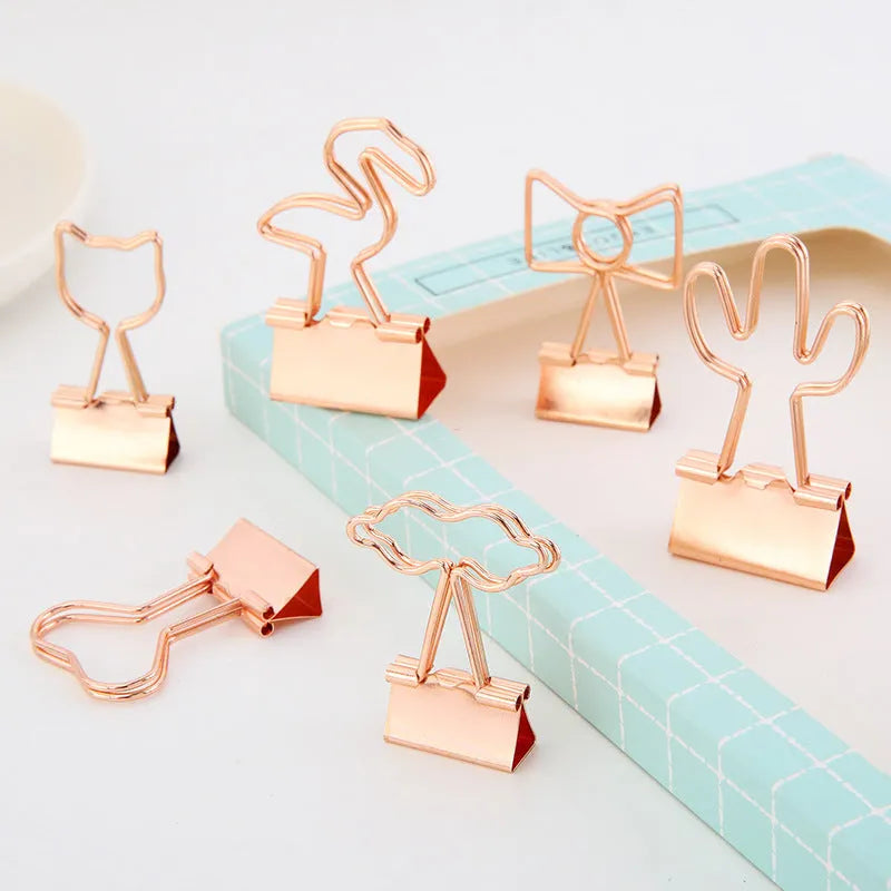Gold-plated decorative binder clips showing flamingo, love, clouds, cat, cactus and bow designs