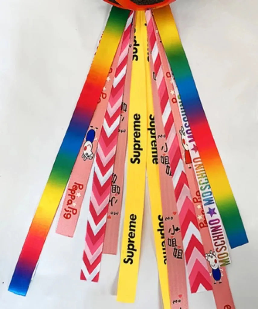 A colourful helmet streamer accessory for children's sports helmets and doll decoration.