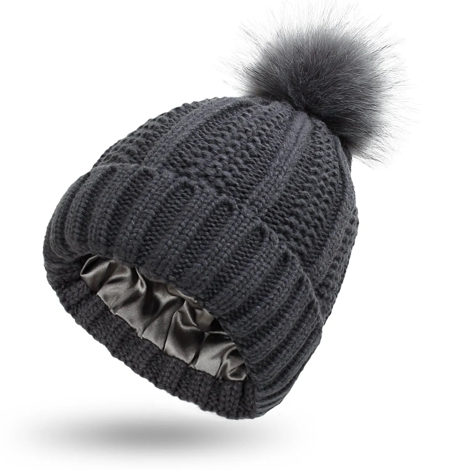 Women's black knit beanie with a faux fur pom pom and satin lining for hair protection