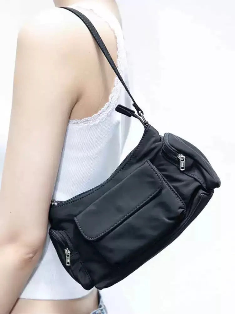 Black lightweight women's shoulder bag made of PU leather with double pockets and side line details.