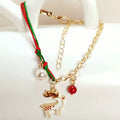 Christmas charm bracelet with alloy chain and festive pendant charms on light background