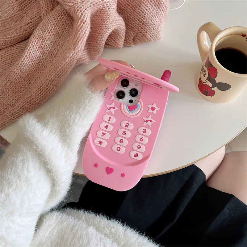 Pink silicone flip phone case open to show built-in mirror and iPhone compatibility.
