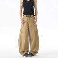 Brown men's loose fit straight leg jeans with a button fly on a mannequin.
