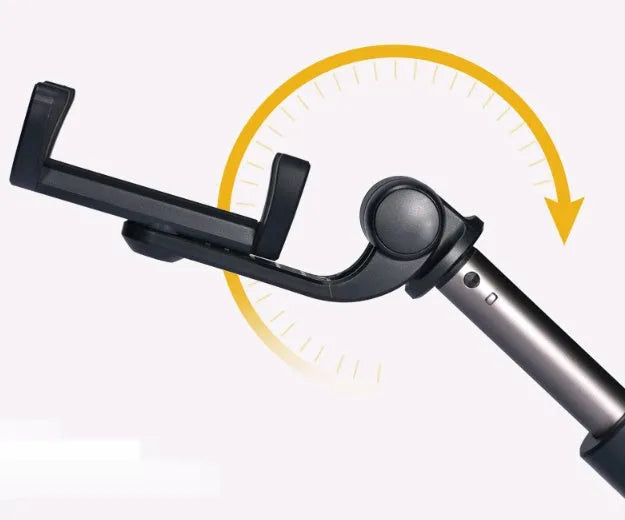 Black Bluetooth selfie stick tripod with extended rod, phone clamp, and deployed legs next to a smartphone