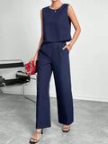 Women's red polyester two-piece set with sleeveless top and wide leg trousers on mannequin