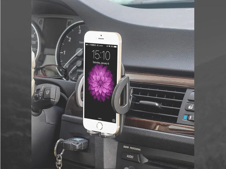 Black plastic car vent phone holder mounted on air conditioning outlet with smartphone