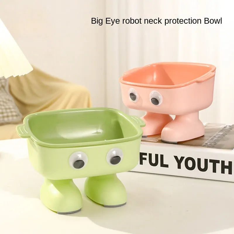 Green robot-shaped elevated cat bowl with tilted food dish and non-slip base.