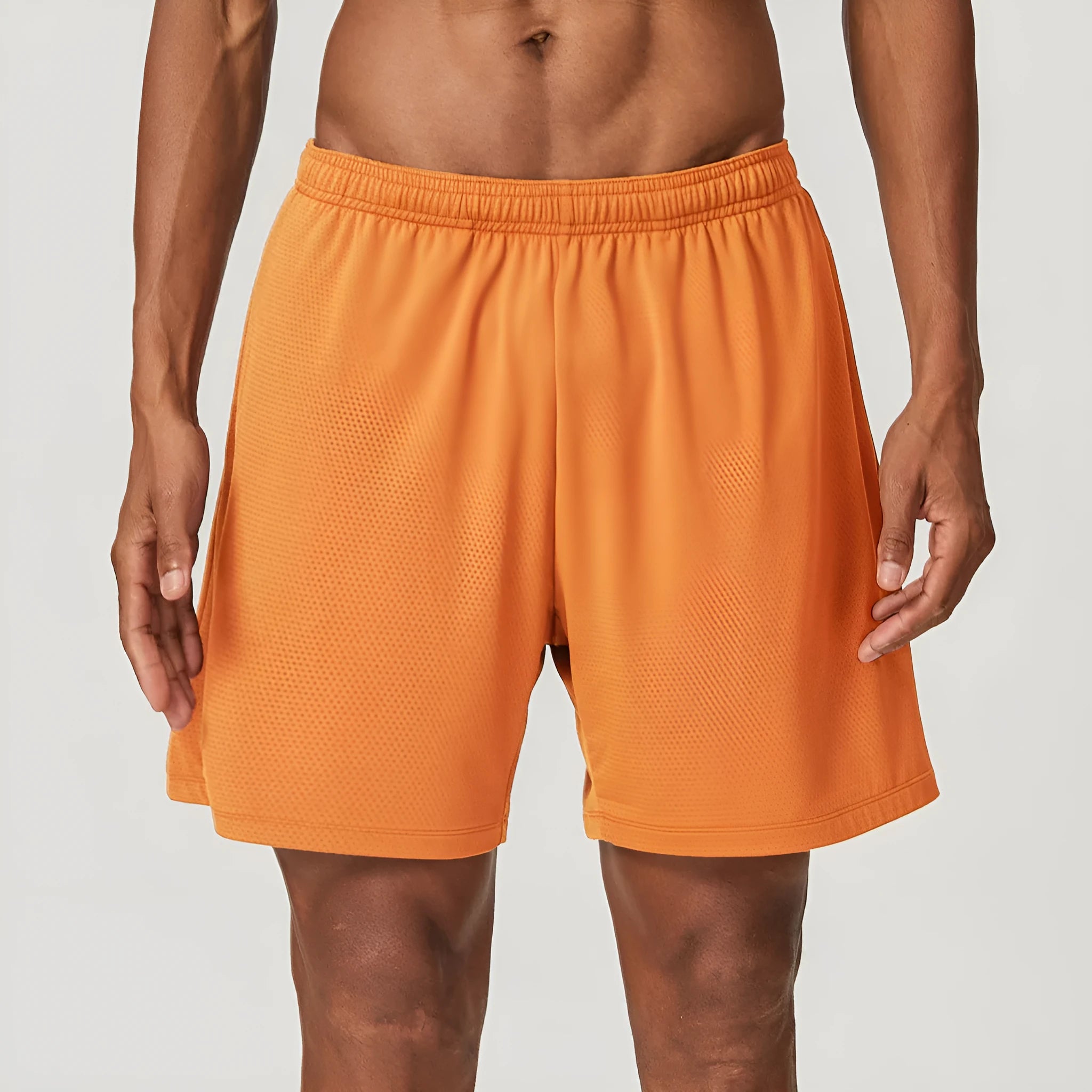 Men's double-layer quick-drying running shorts in brick red colour on a mid-waist model.