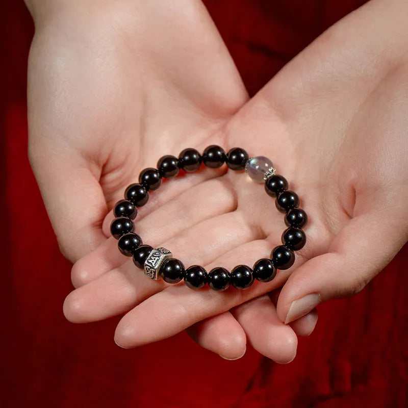 Obsidian zodiac bracelet with 8mm beads showing carved animal and bodhisattva designs in Chinese ethnic style
