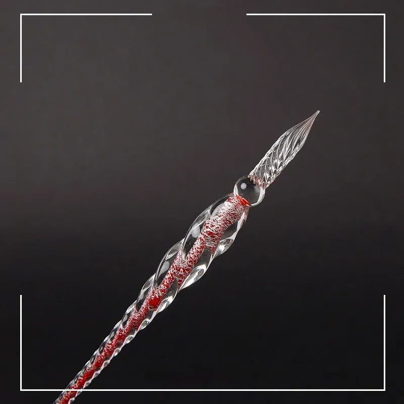 Hand-blown glass crystal pen with coloured ink in a transparent barrel on a gift box.