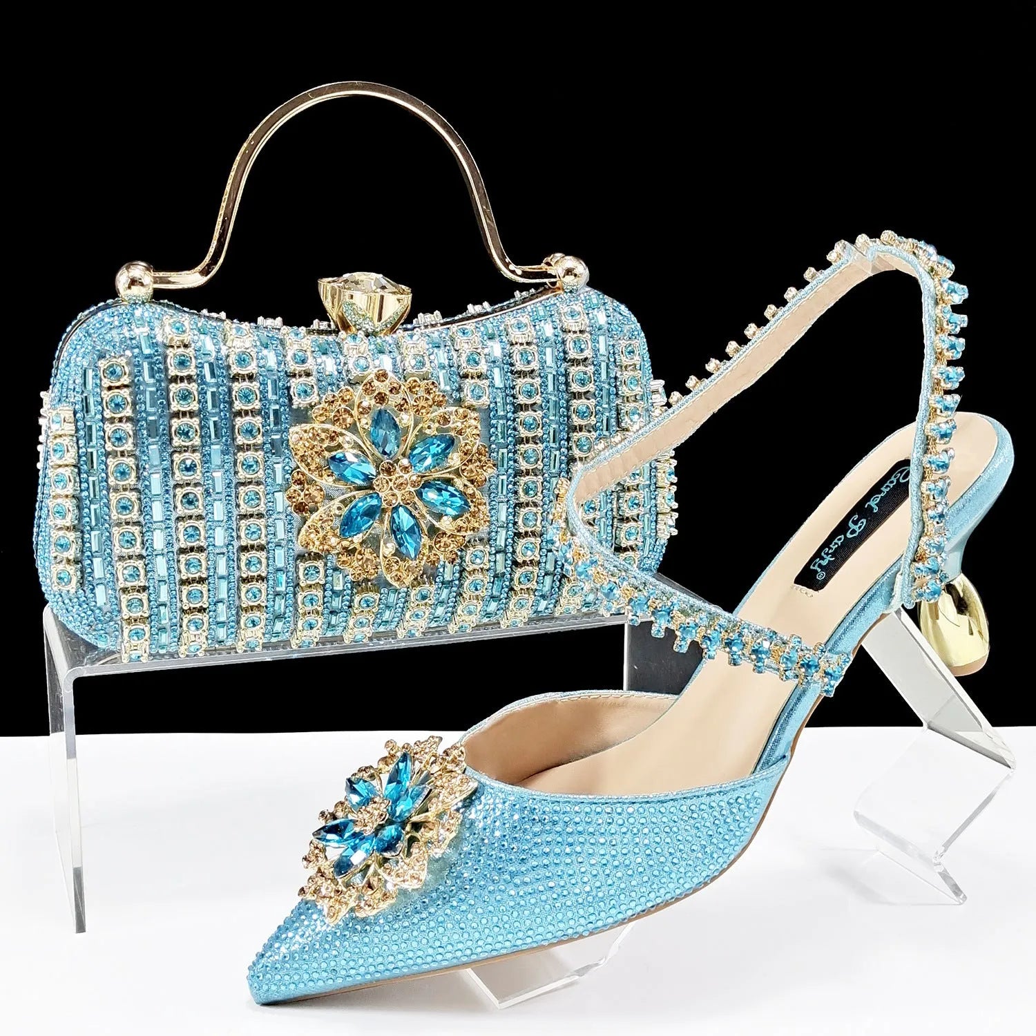 Women's high heel shoes with matching clutch bag featuring decorative flower buckle and ankle chain detail