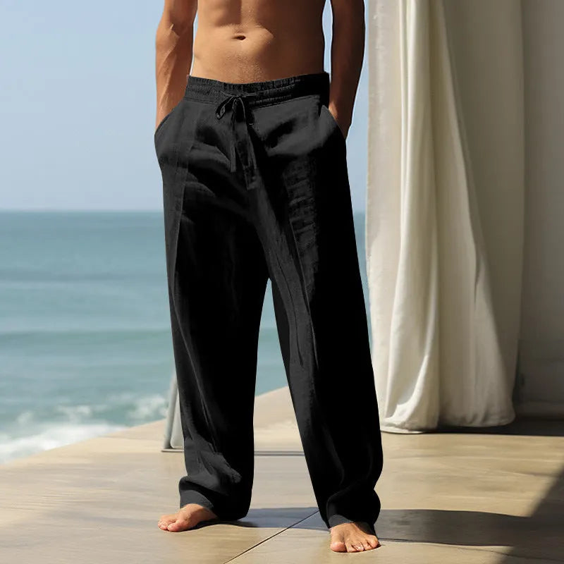 Men's loose-fit cotton casual trousers in a solid colour on a hanger.