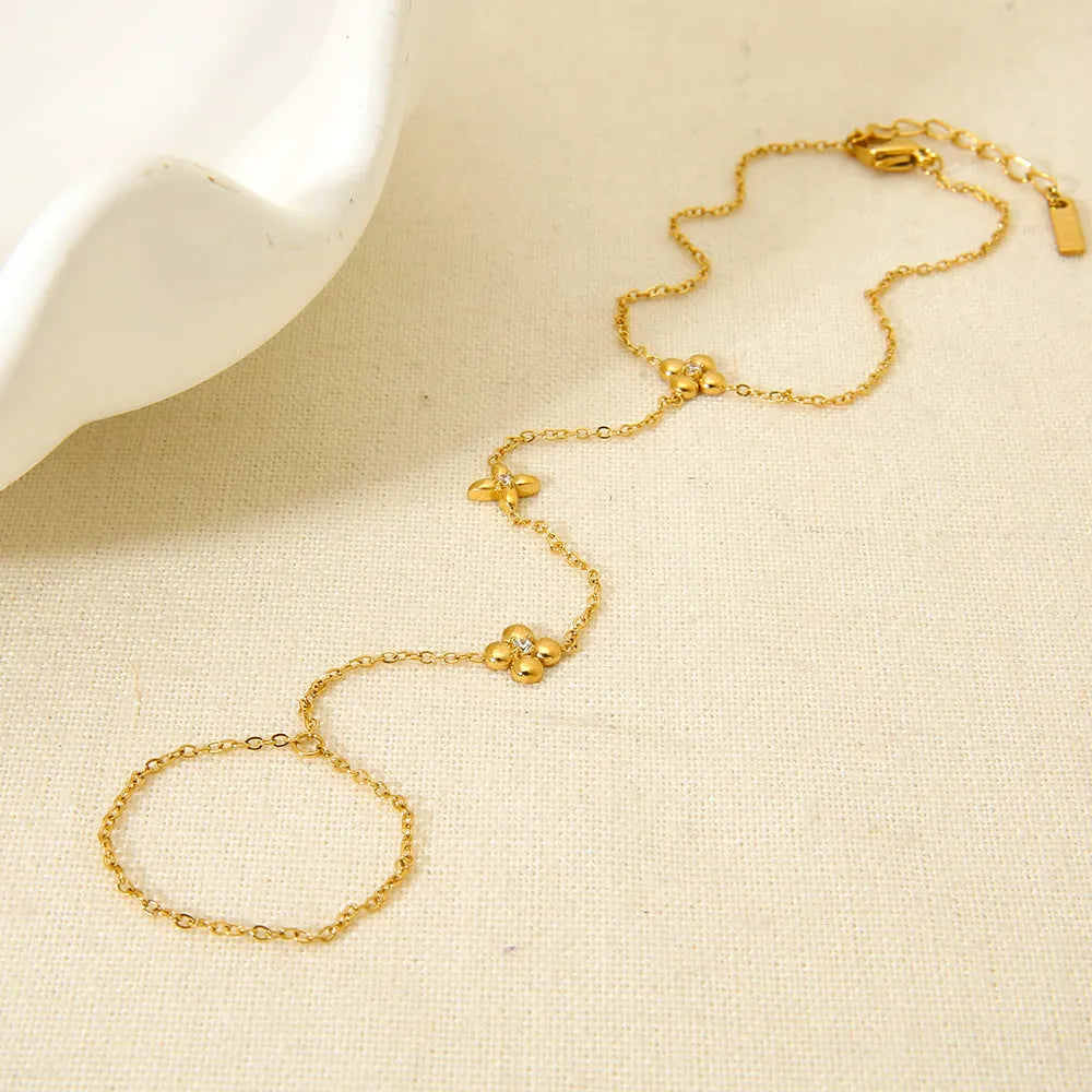 Gold women's stainless steel bracelet with an eight-pointed star and floral geometric design.