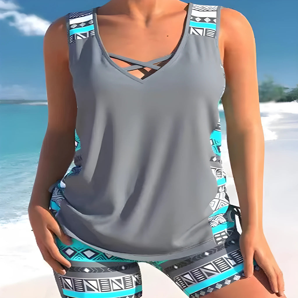 Women's blue printed lace two-piece swimsuit top and shorts laid flat.