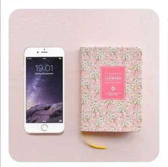 Green fabric imitation leather floral notepad open on a desk, showing custom logo printing and Daolin paper.