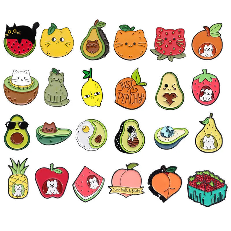 Colourful cartoon fruit design metal brooch with pin back on a fabric background.