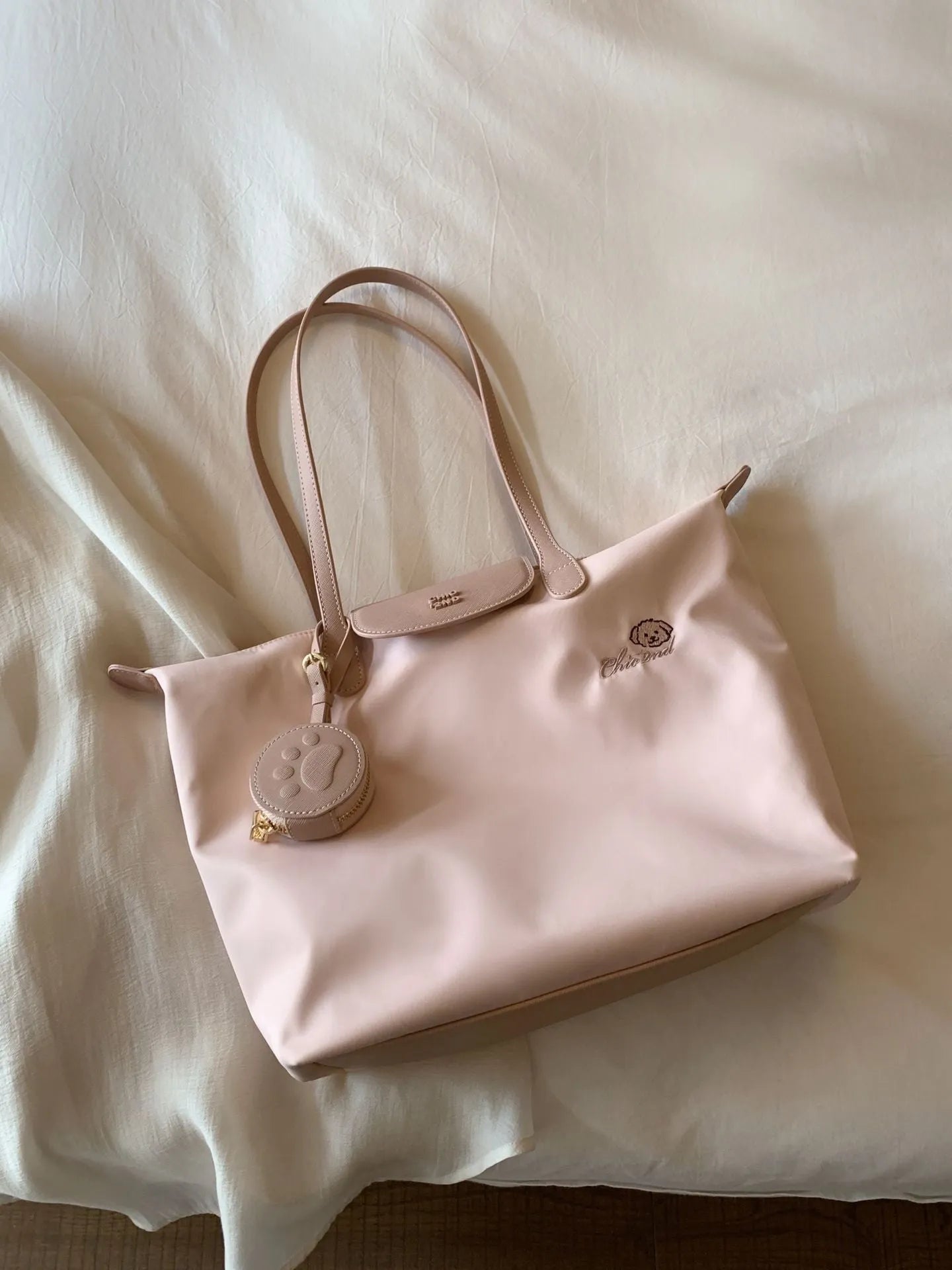 Pink Oxford cloth shoulder tote with sandwich pockets and square shape showing internal mobile phone compartment