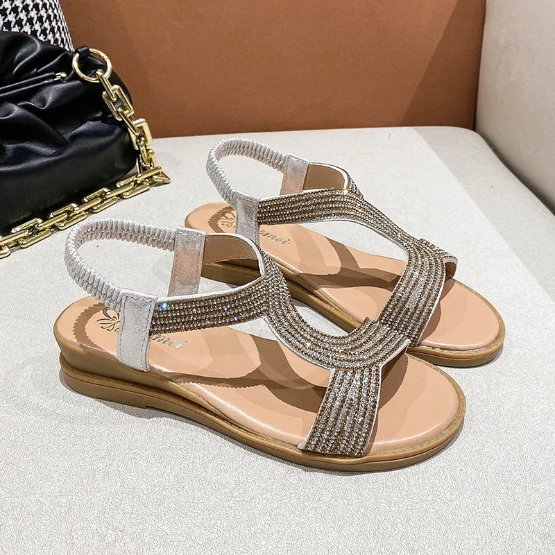 Gold women's patent leather sandals with rhinestone decoration and a non-slip sole.