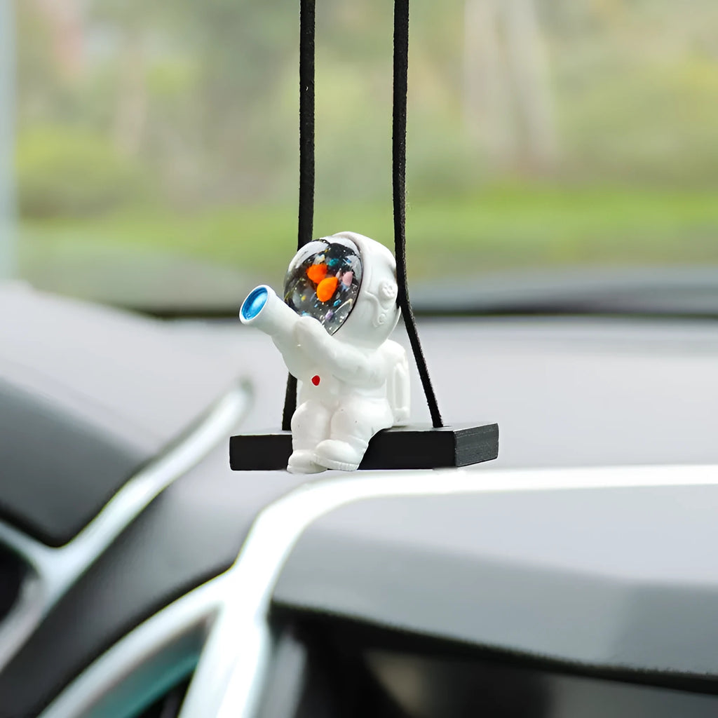 Resin cartoon astronaut car pendant available in red flag, telescope, and radish holding styles for dashboard decoration.