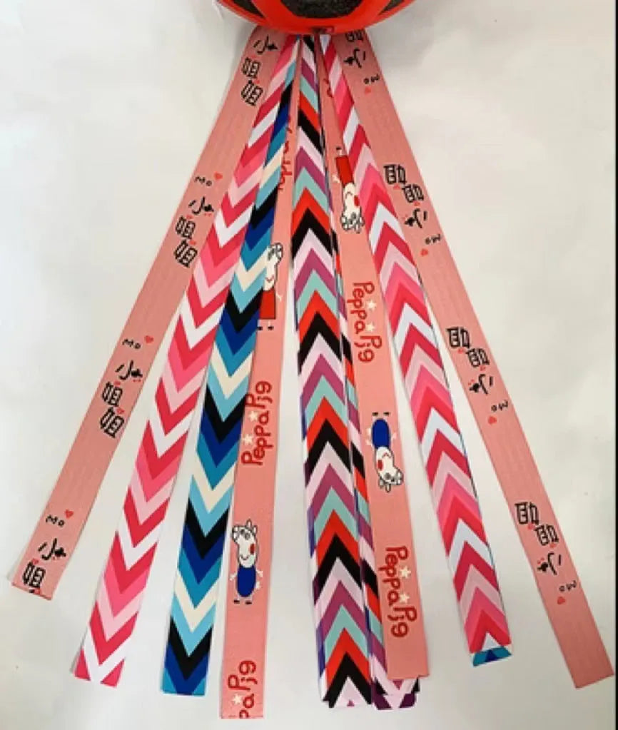 A colourful helmet streamer accessory for children's sports helmets and doll decoration.