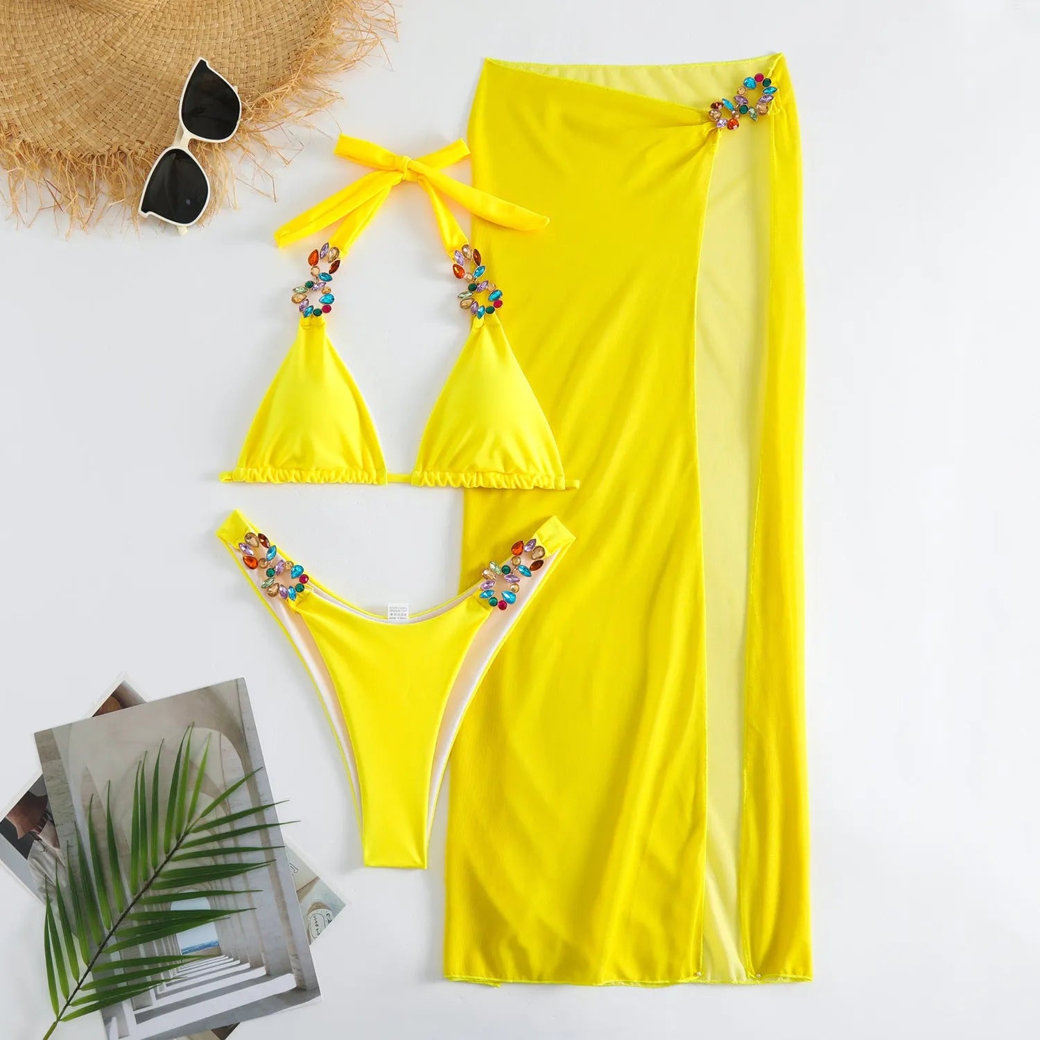 Rose red mesh long skirt three-piece bikini swimsuit set laid flat.
