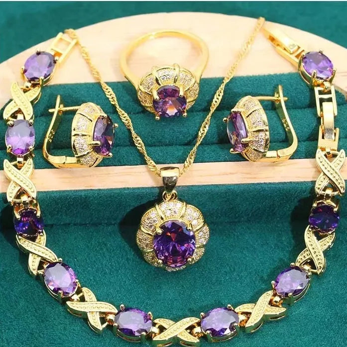 18k gold plated jewellery set showing necklace, earrings, ring and bracelet with coloured cubic zirconia stones.