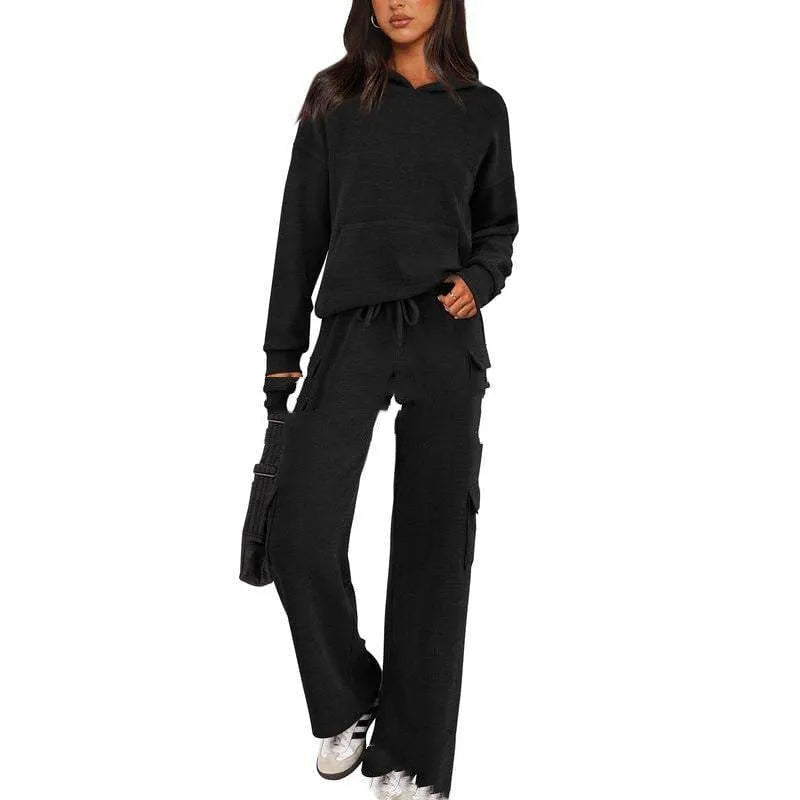 Women's two-piece leisure sports suit in polyester, showing long sleeve top and trousers in a solid colour.