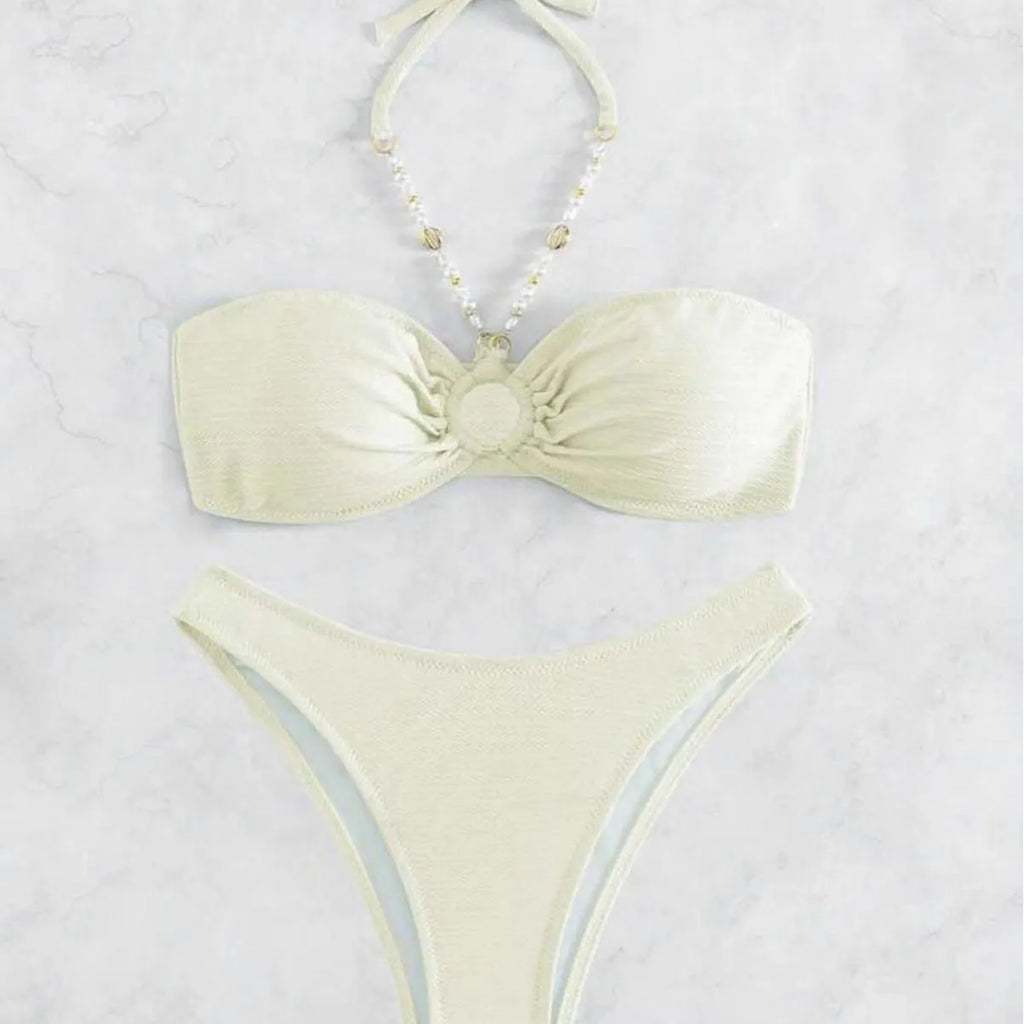 Women's solid colour halter bikini set on a mannequin, showing the halter top and briefs.