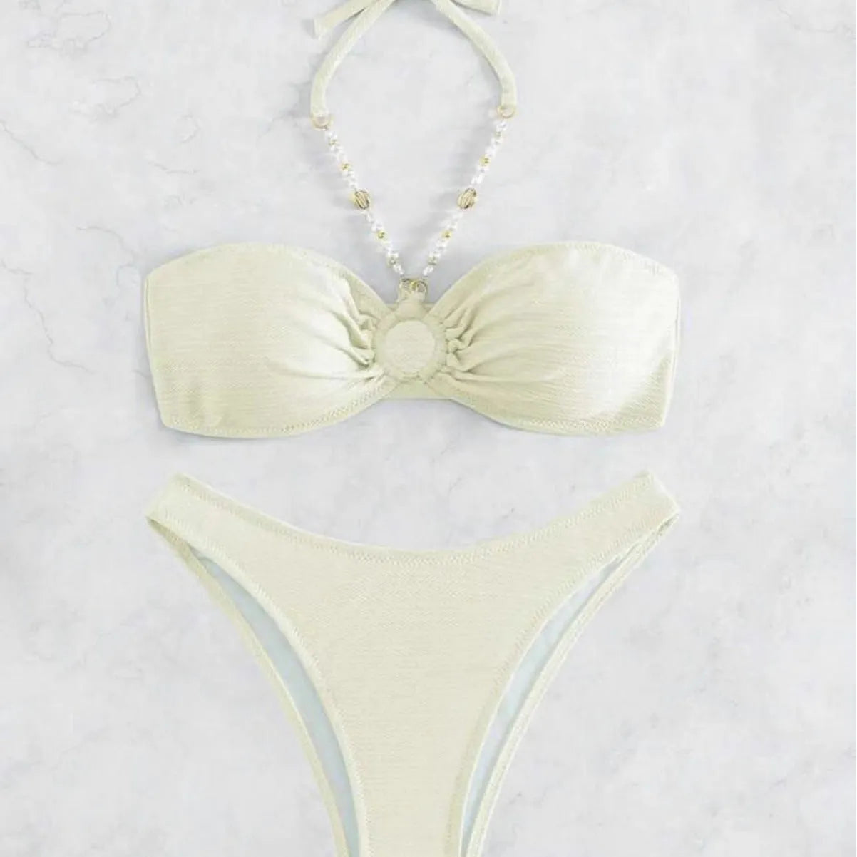 Women's solid colour halter bikini set on a mannequin, showing the halter top and briefs.