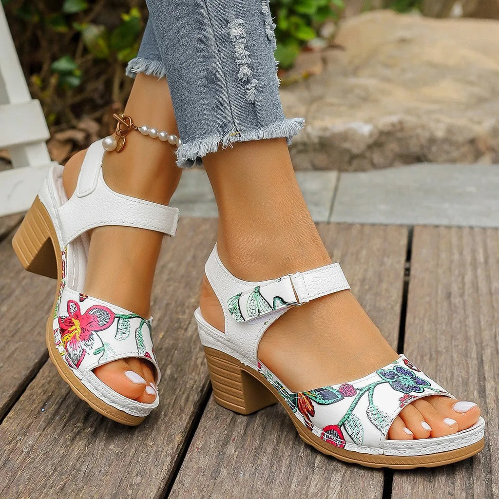 White women's casual high heel sandals with a prominent Velcro strap buckle closure.