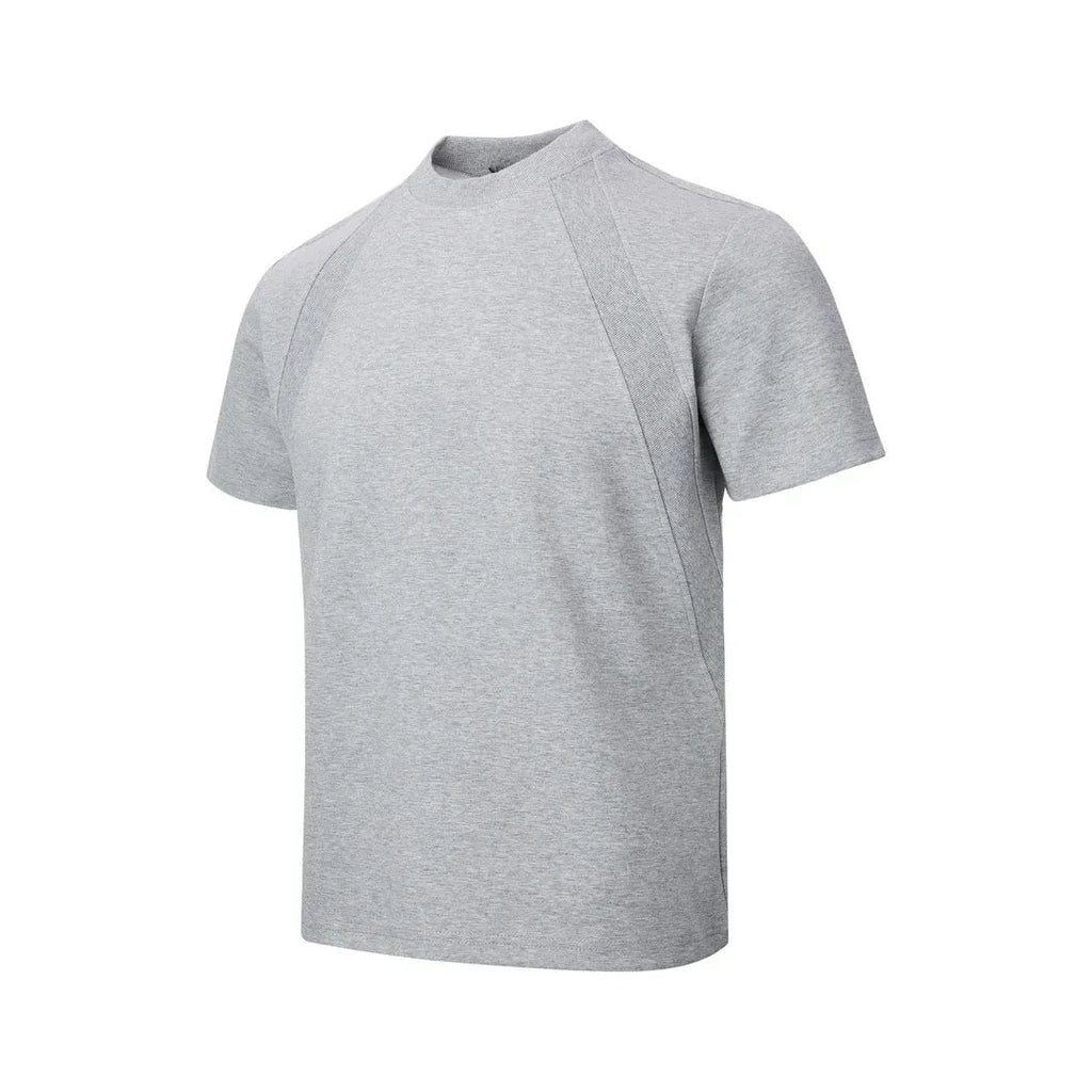 Man wearing a loose-fit grey short sleeve polyester top with air layer stitching.