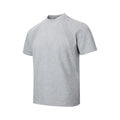 Man wearing a loose-fit grey short sleeve polyester top with air layer stitching.