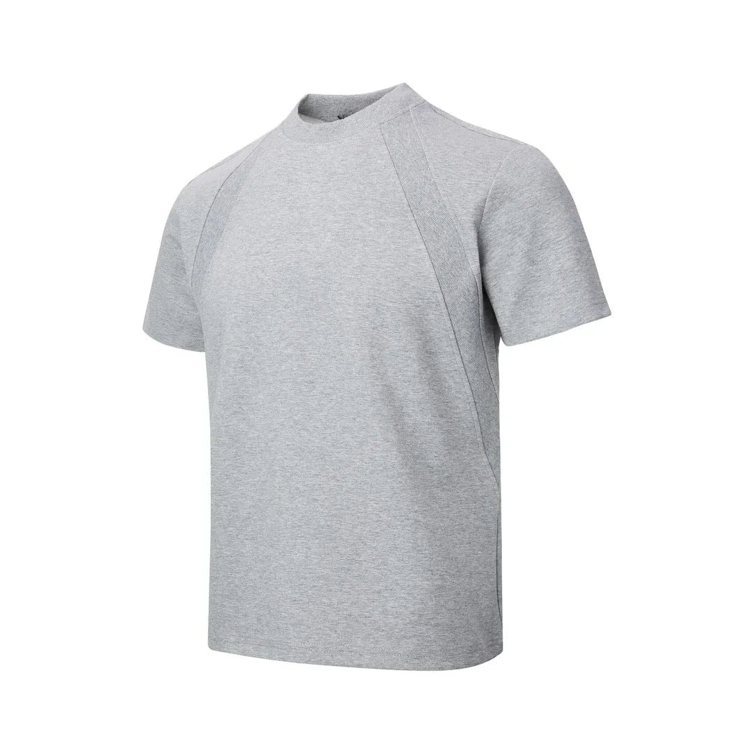 Man wearing a loose-fit grey short sleeve polyester top with air layer stitching.