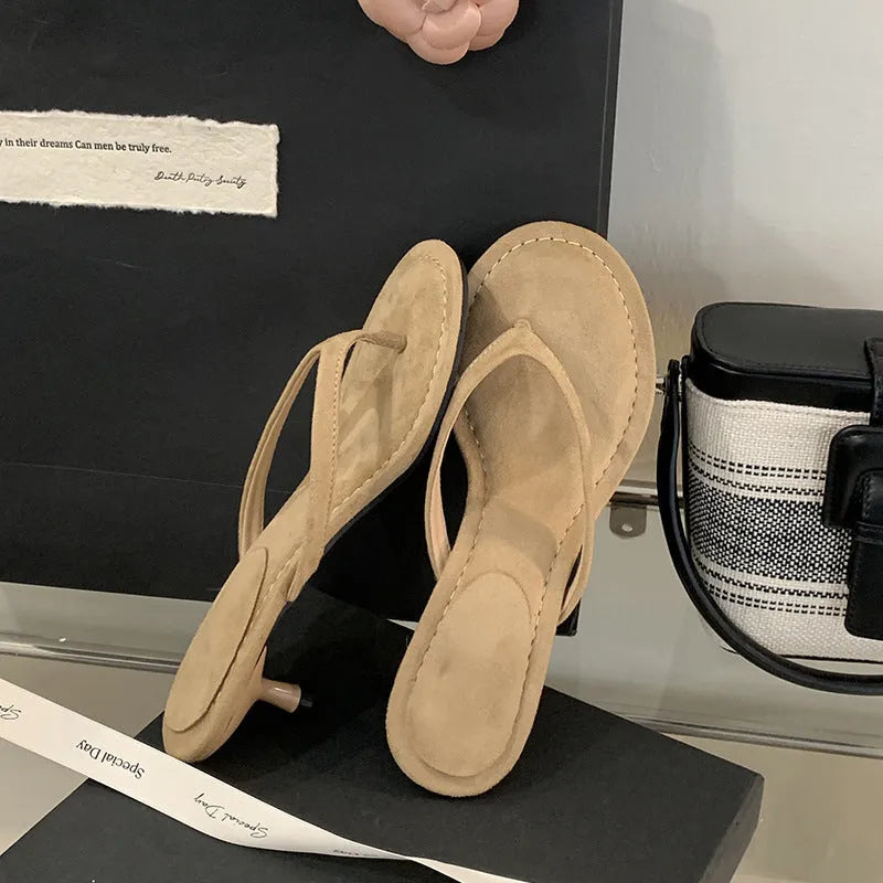 Women's rubber stiletto flip-flop sandals in black and camel colours on a white background.