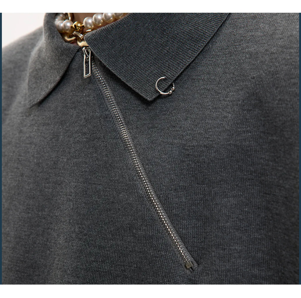 Men's slim-fit black knitted polo shirt with an oblique diagonal zipper and lapel collar.