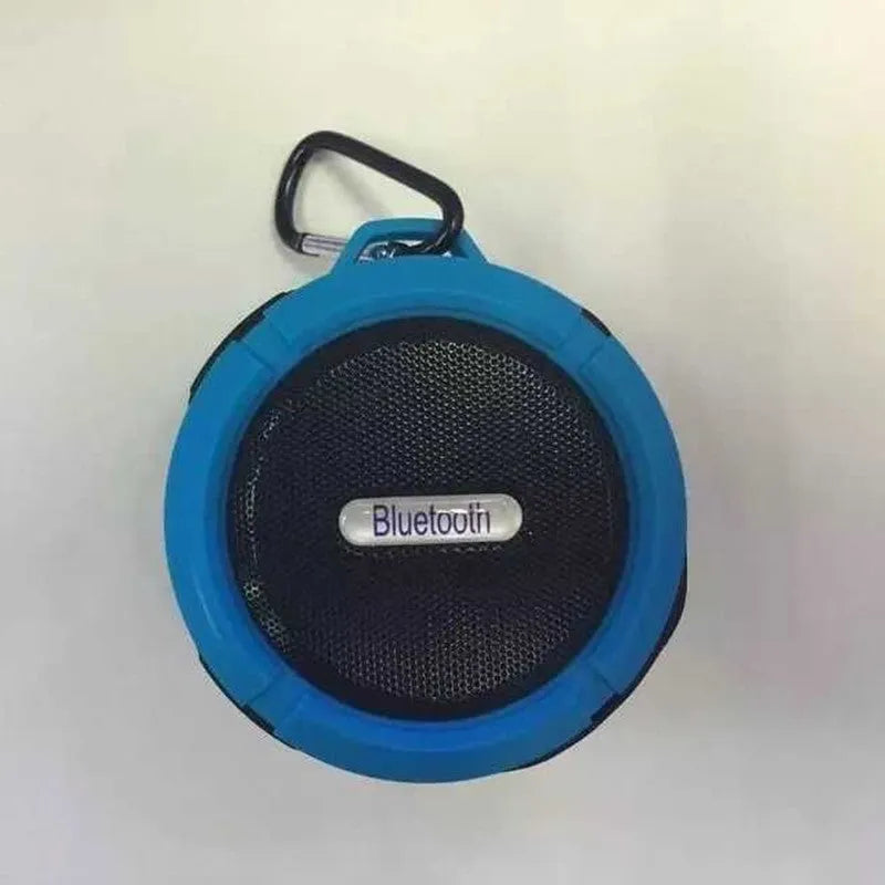 Portable waterproof Bluetooth speaker in multiple colours with a mountaineering buckle for bag attachment.