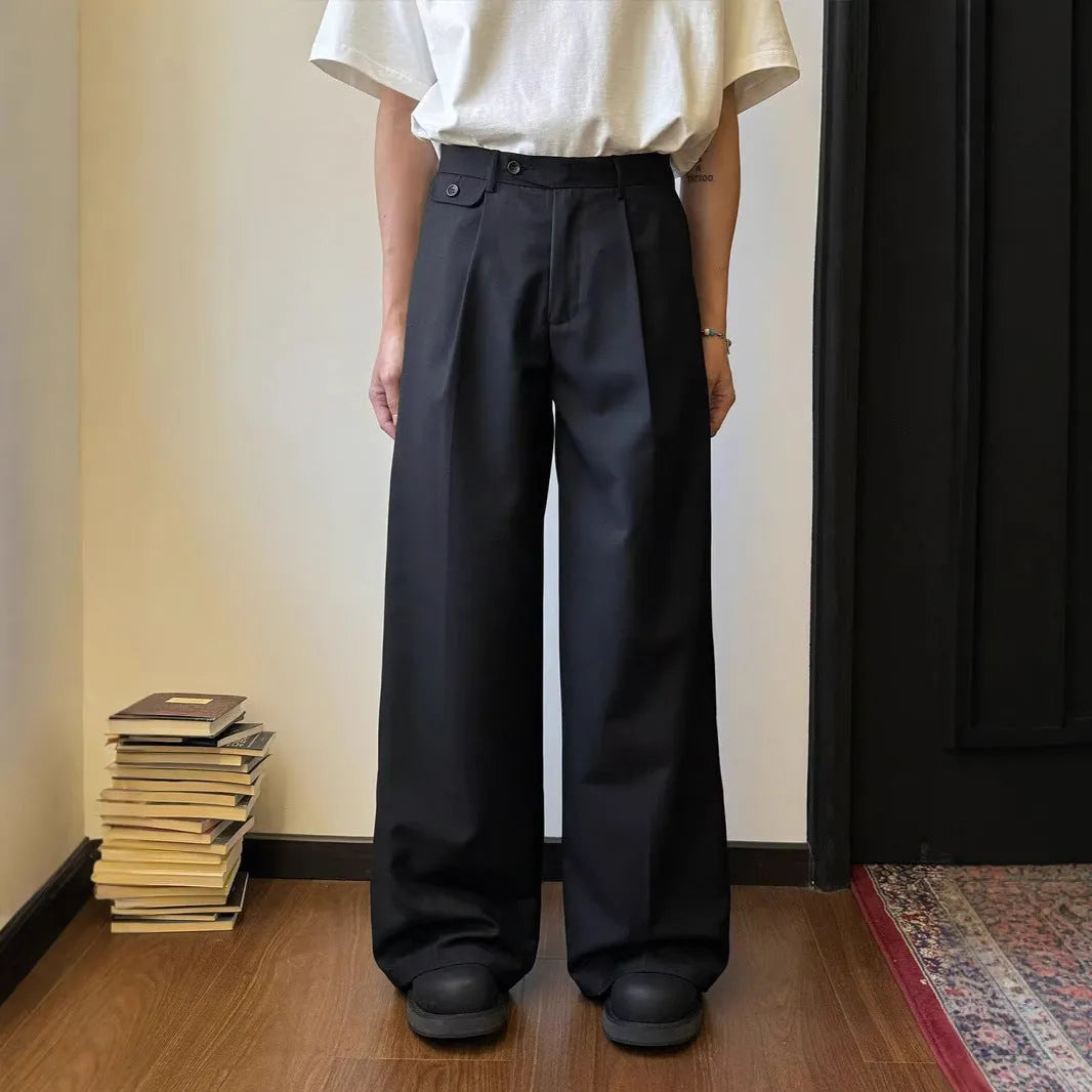 Men's straight-leg loose-fit trousers in brown and black colours on a hanger.