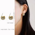 Geometric drop-shaped ear clip earrings with full diamond little golden beans detailing in gold and white finishes