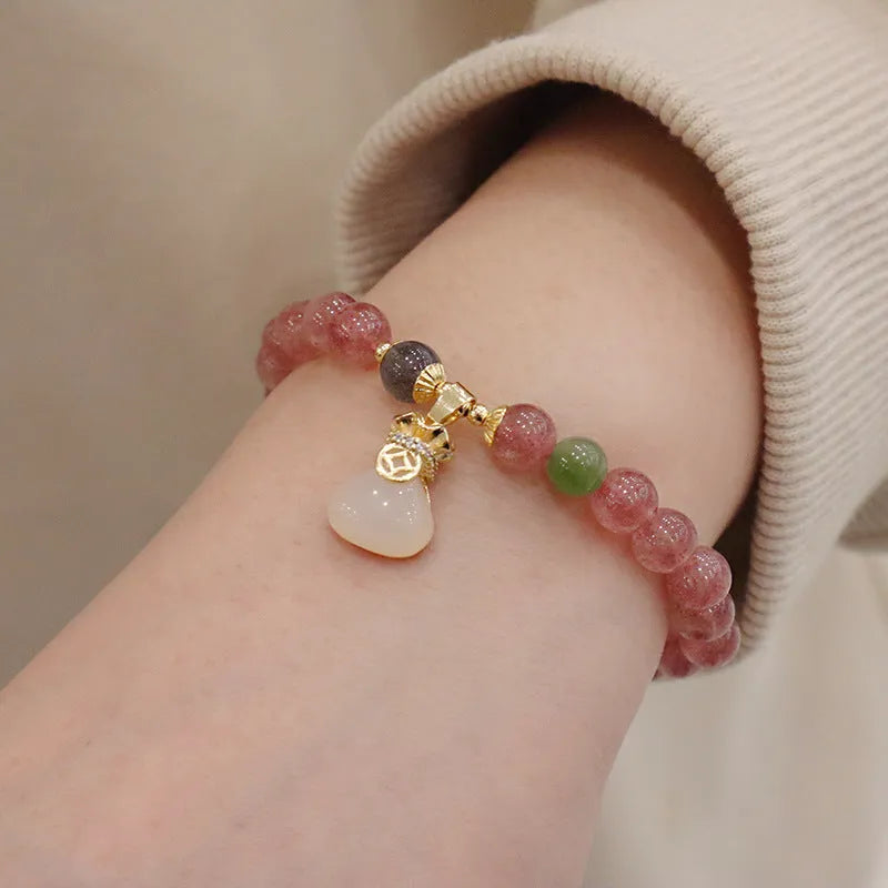 Geometric Strawberry Quartz women's bracelet with a lucky Bagg charm and a silver safety buckle clasp.