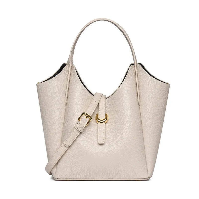 Genuine leather women's retro bucket handbag in beige with top handles and visible stitching.