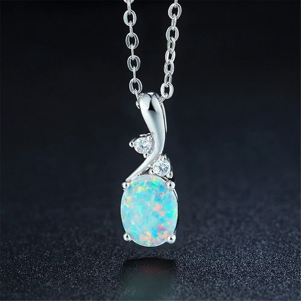 Close-up of a water drop shaped opal pendant on an adjustable O-link chain, shown in a rose gold finish.