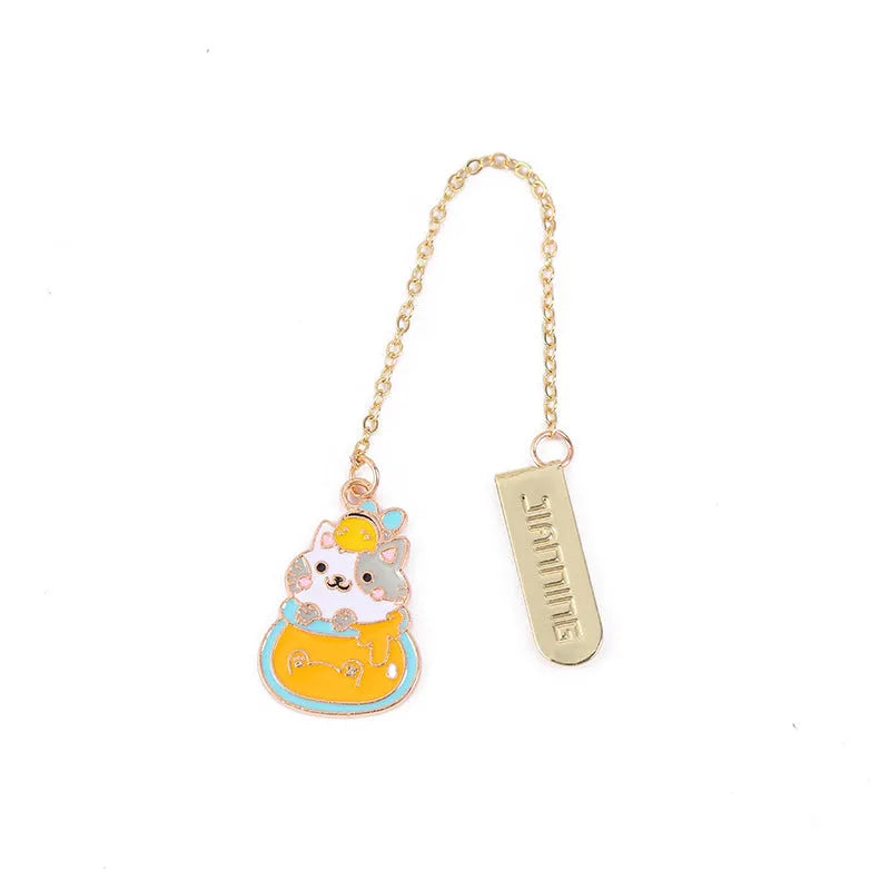 Metal cartoon cat bookmark with food-themed designs including strawberry cake and fruit roll styles
